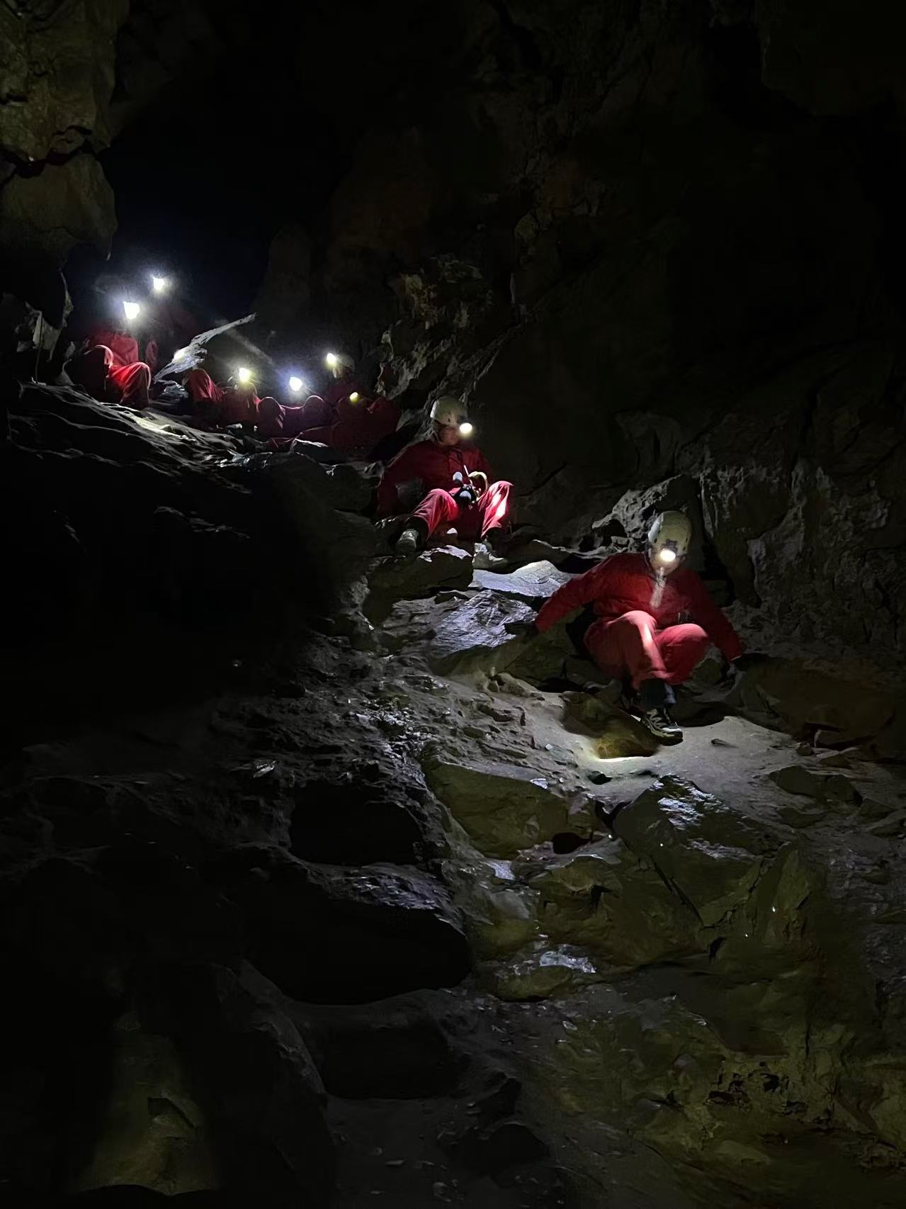 Cave exploration in the Rocky Mountains with helmets and headlamps