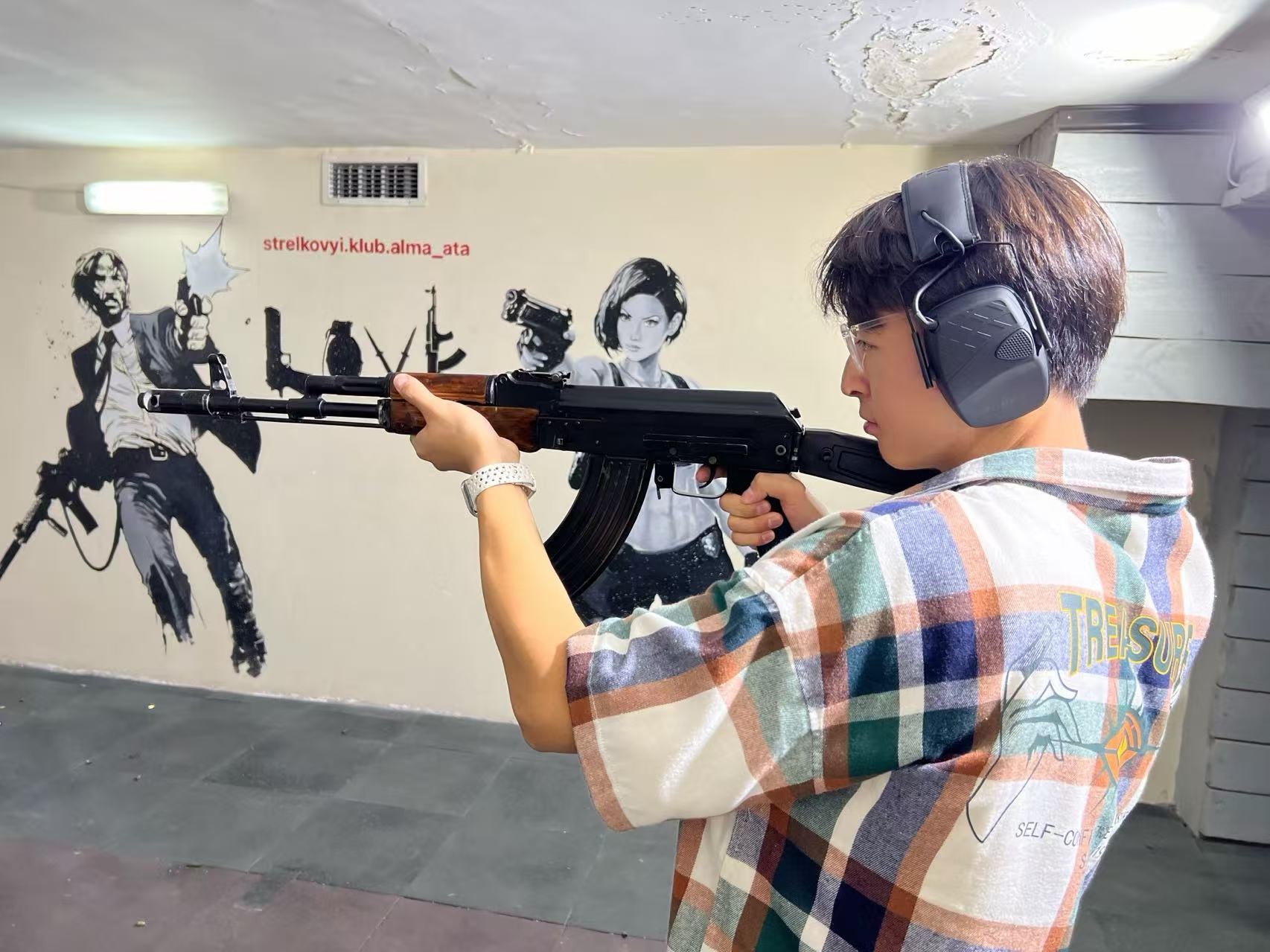 Shooting at an indoor range with protective glasses and ear defenders